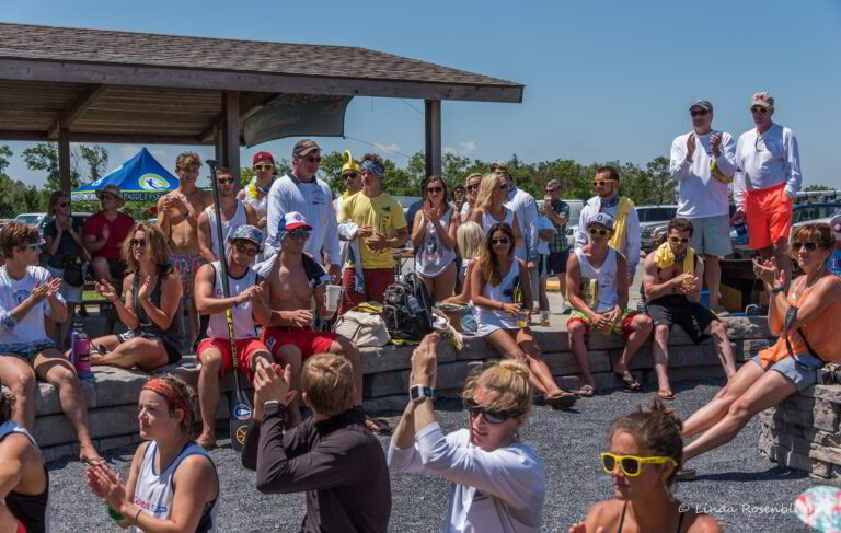 a group of people sitting and standing around each other