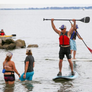 a group of people on paddle boards in the water