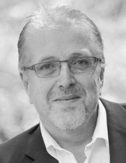 a black and white photo of a man wearing glasses