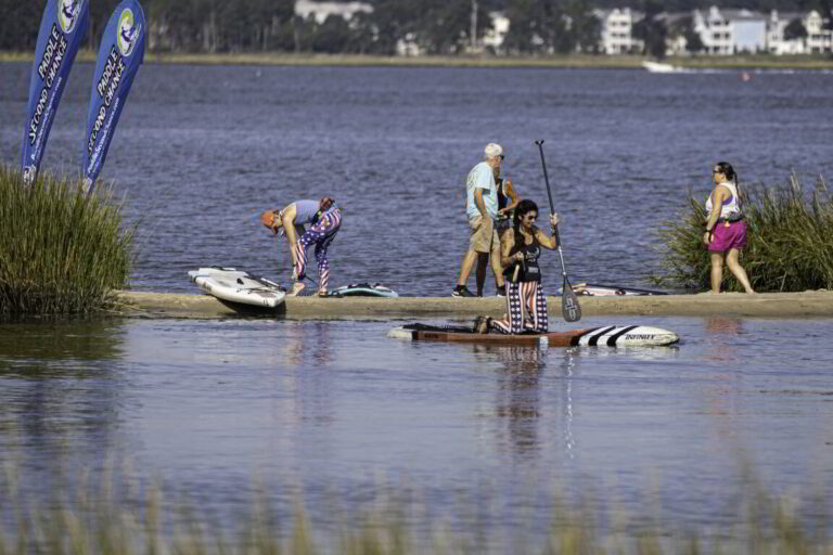 a group of people standing on top of a boat
