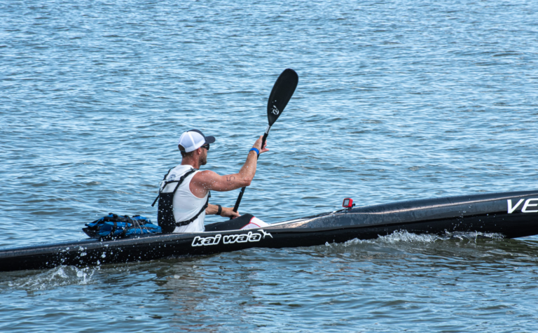 a man in a kayak paddles through the water