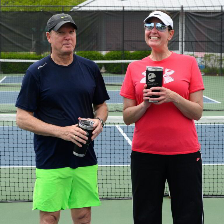 a man and woman standing on a tennis court