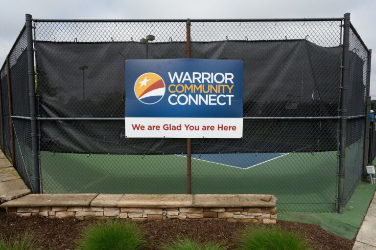 a sign that is on the side of a fence