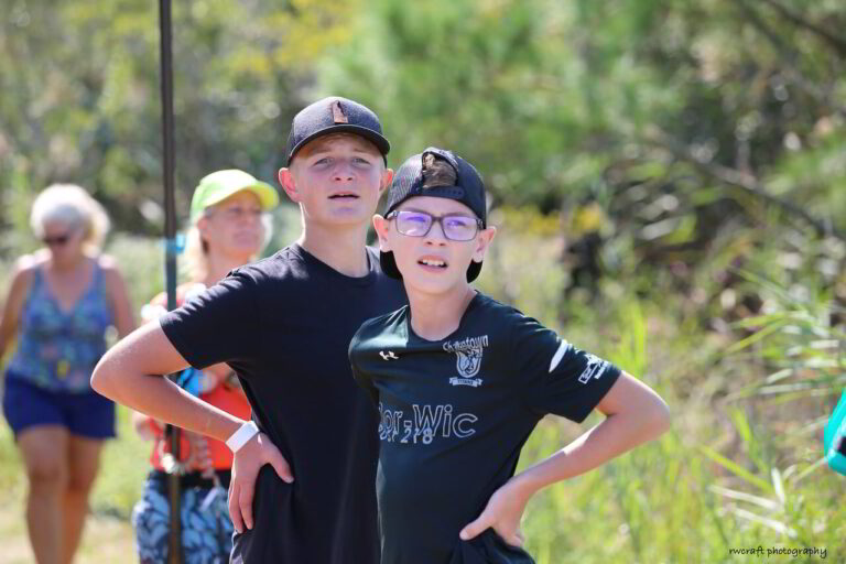 two young boys standing next to each other