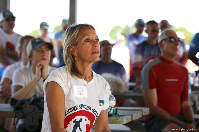 a woman sitting in front of a group of people