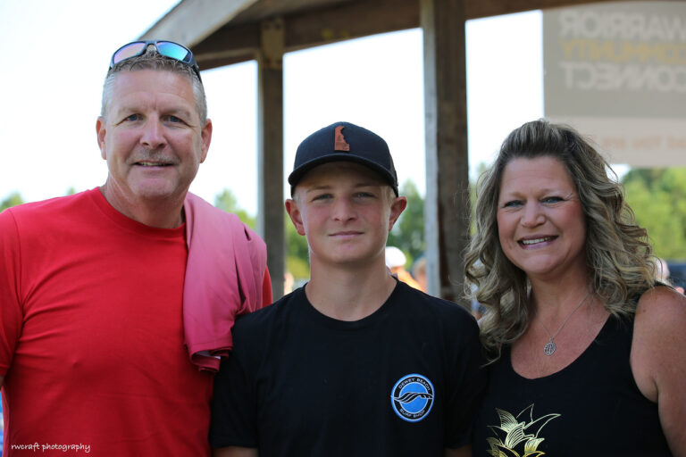 a man, woman and boy posing for a picture