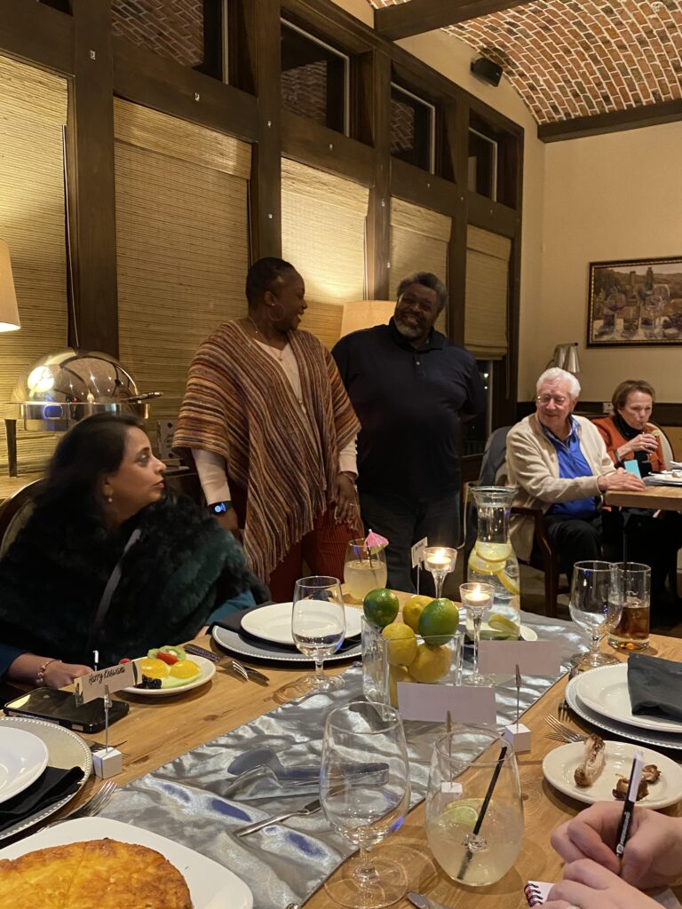 a group of people sitting at a table with food on it