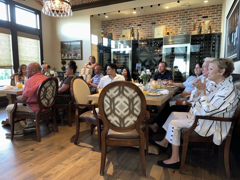 a group of people sitting around a table eating food
