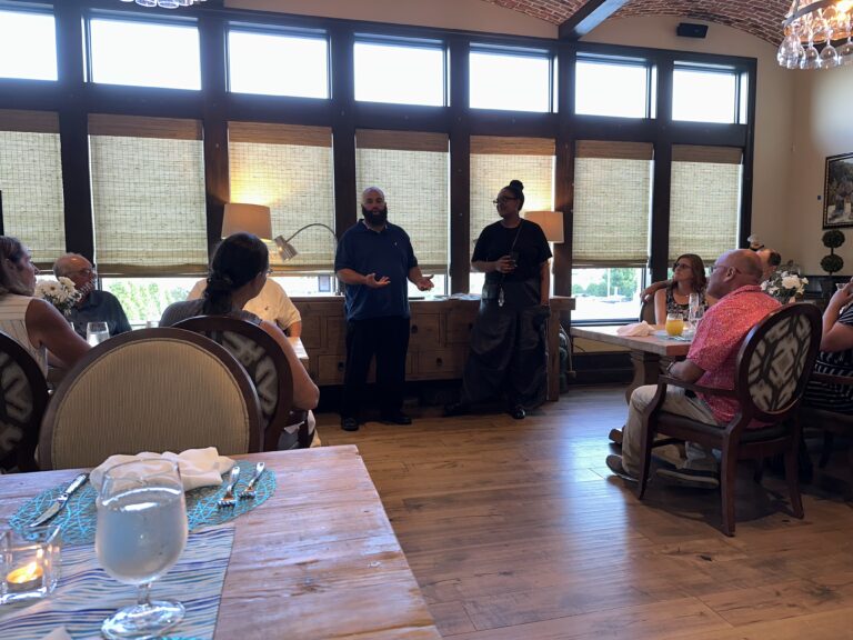 a group of people sitting at tables in a restaurant