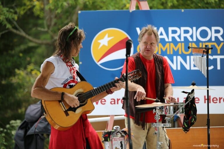 two men are playing instruments on stage