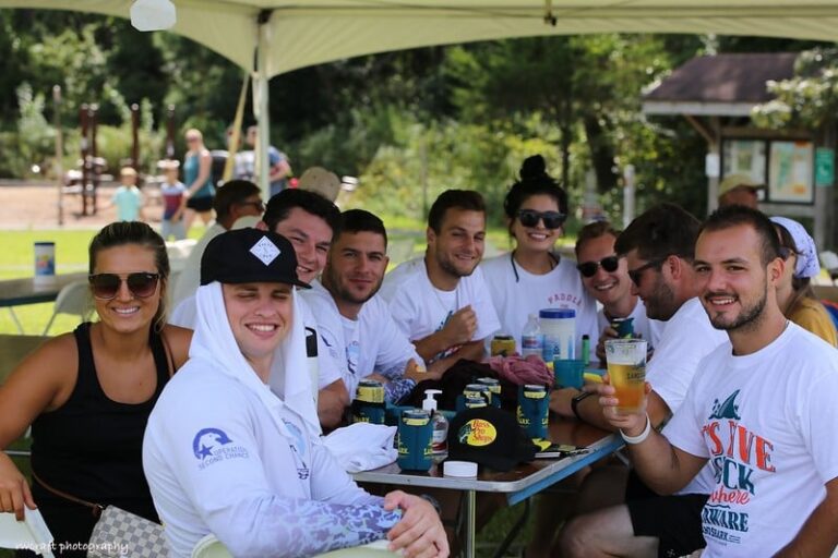 a group of people sitting around a table with drinks