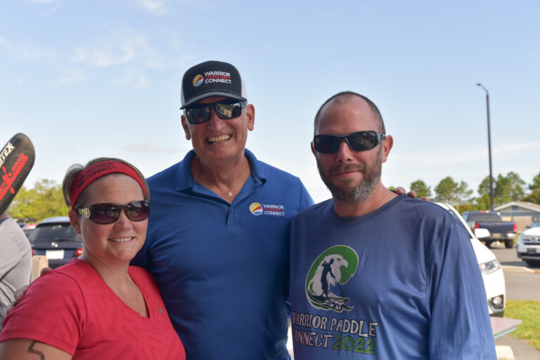 two men and a woman standing next to each other