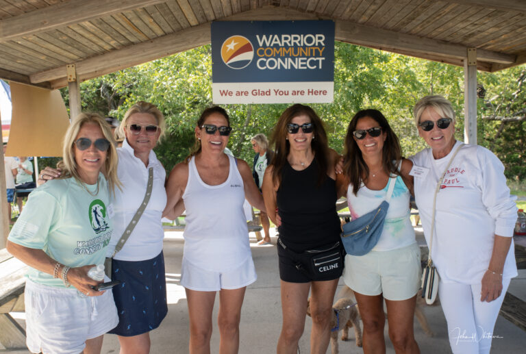 a group of women standing under a covered area