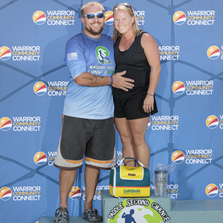a man and woman standing on a podium together