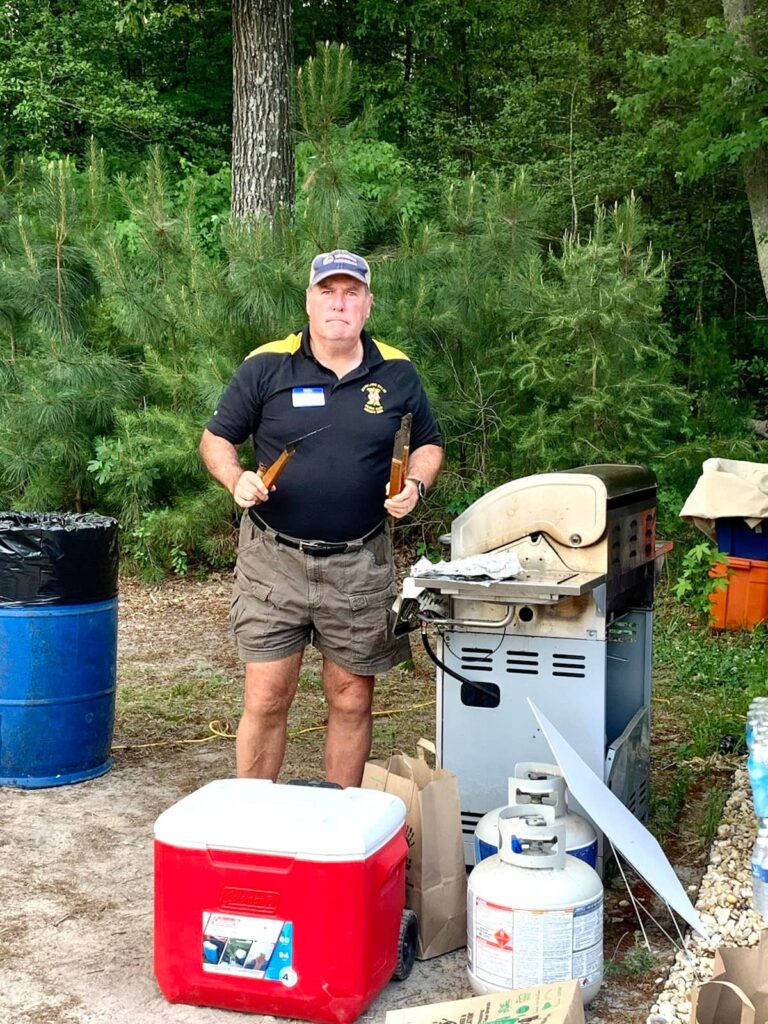 a man standing next to a propane gas tank