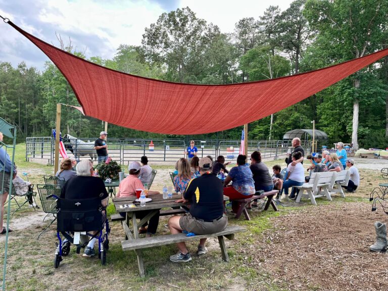 a group of people sitting around a picnic table