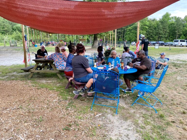 a group of people sitting around a blue table
