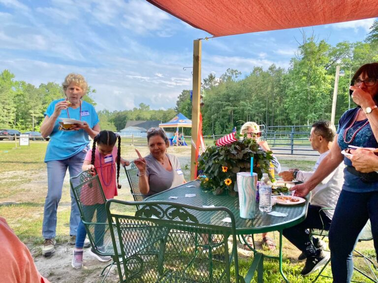 a group of people sitting around a table eating food