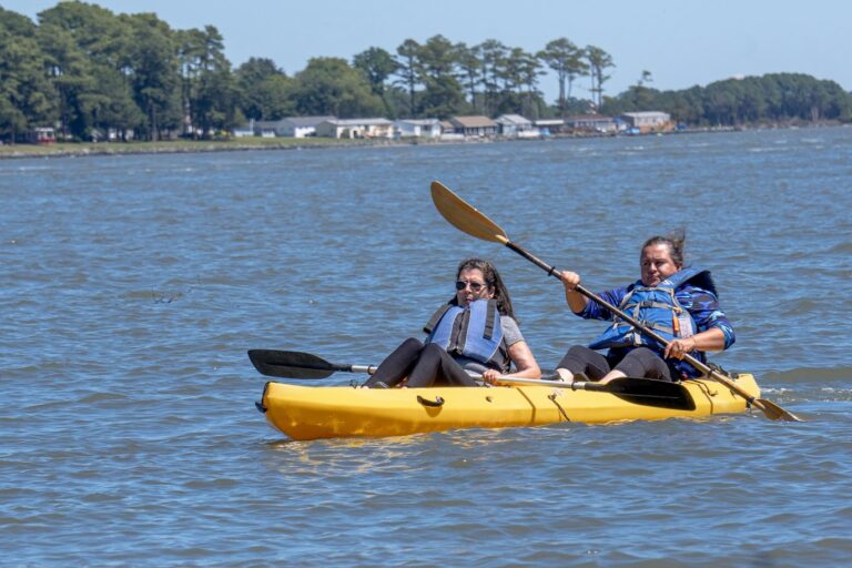 two people in a yellow kayak on the water