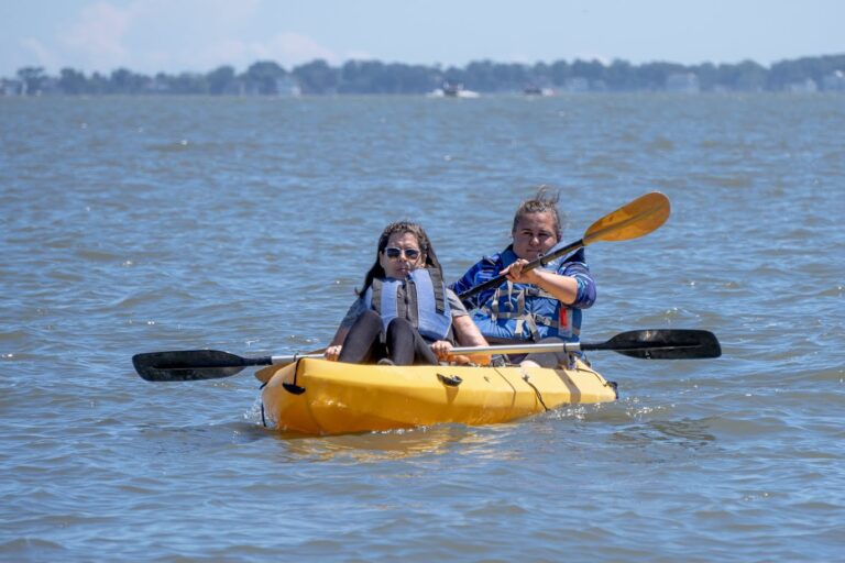 two people in a yellow kayak on the water