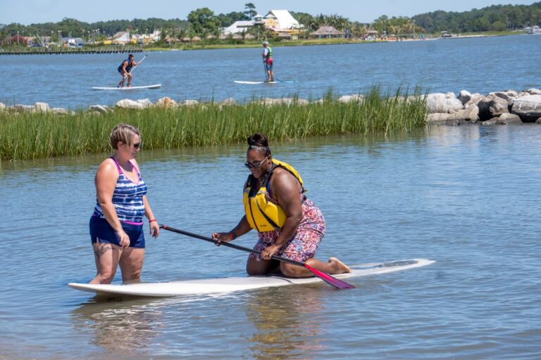 two women on a surfboard in the water