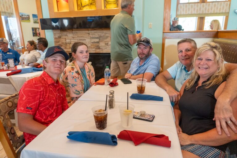 a group of people sitting at a table in a restaurant