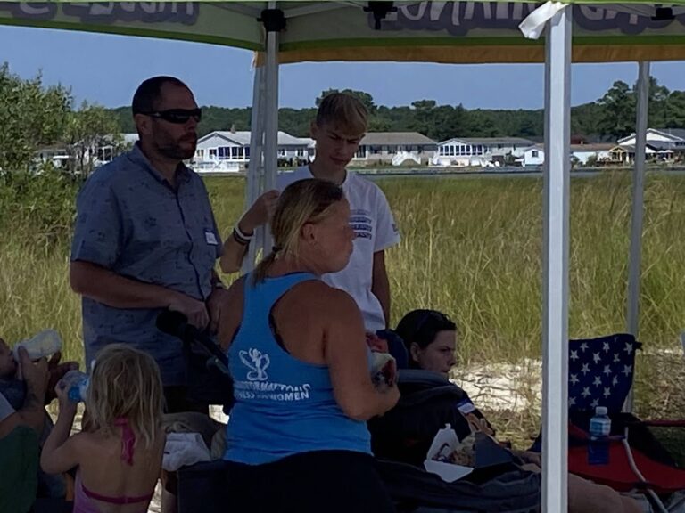 a group of people standing under a tent