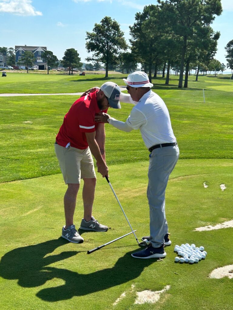 two men are playing golf on the green