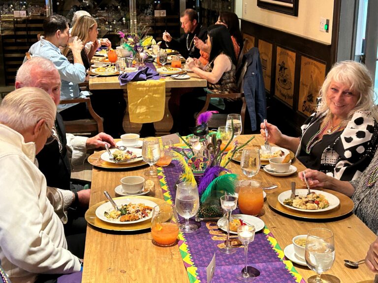 a group of people sitting around a table eating food