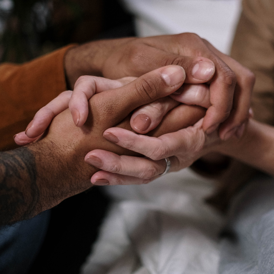 a close up of two people holding hands