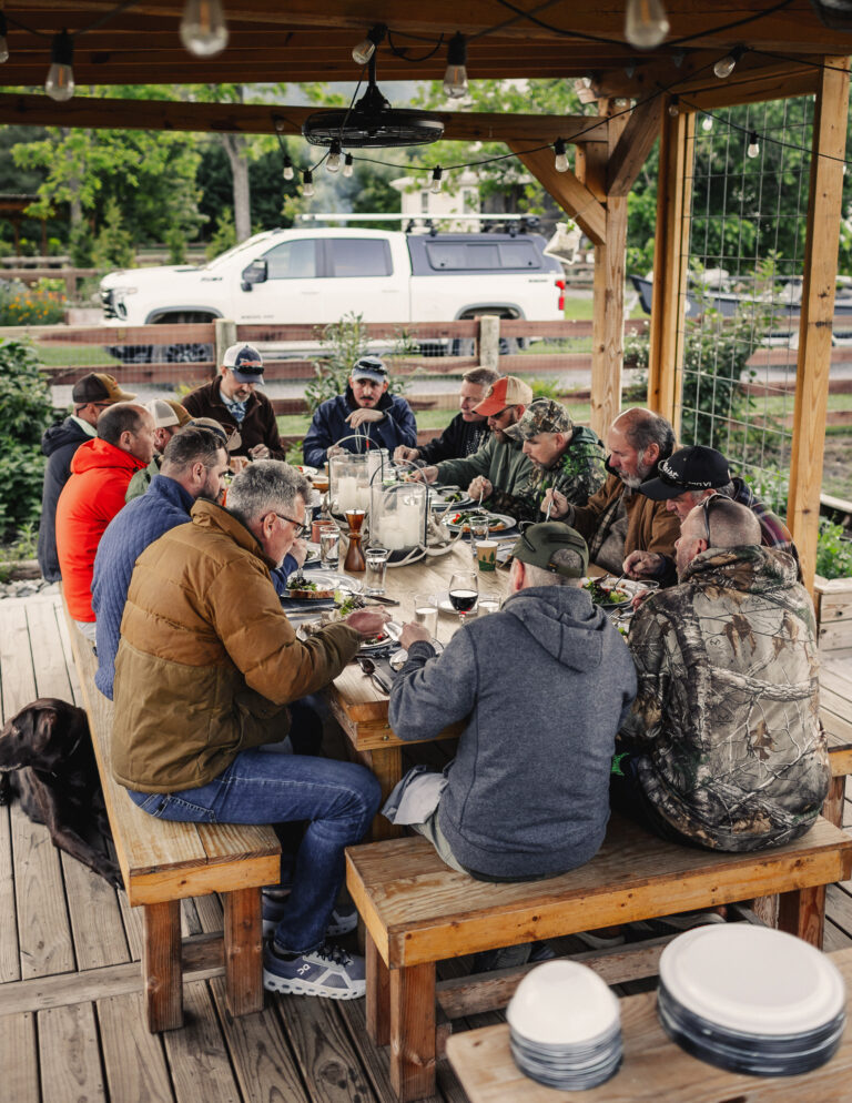 a group of people sitting at a picnic table
