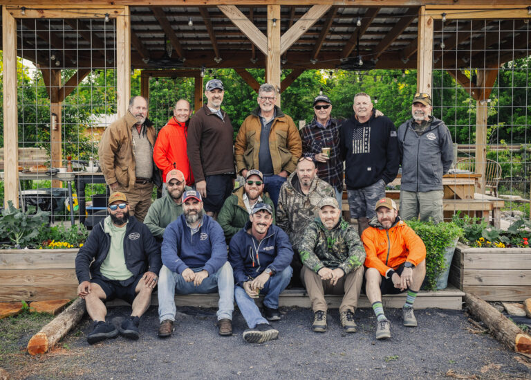 a group of people posing for a picture in a garden