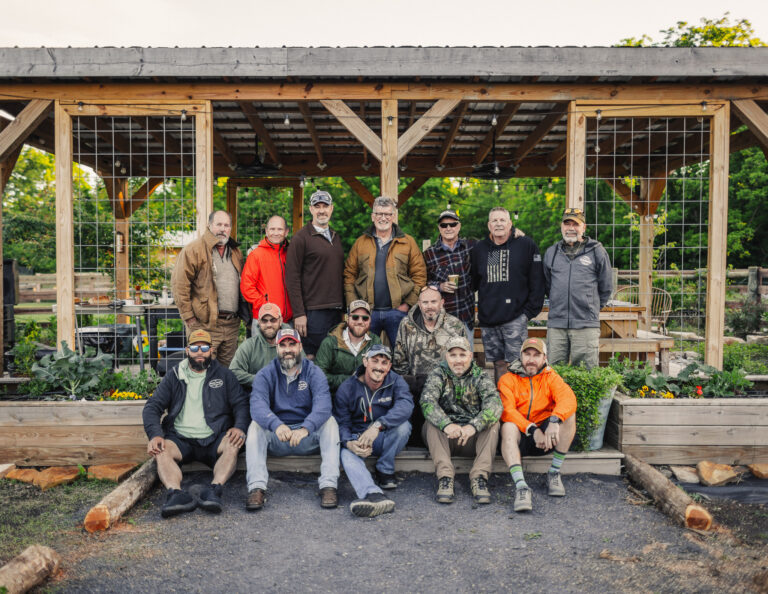 a group of people posing for a picture in a garden