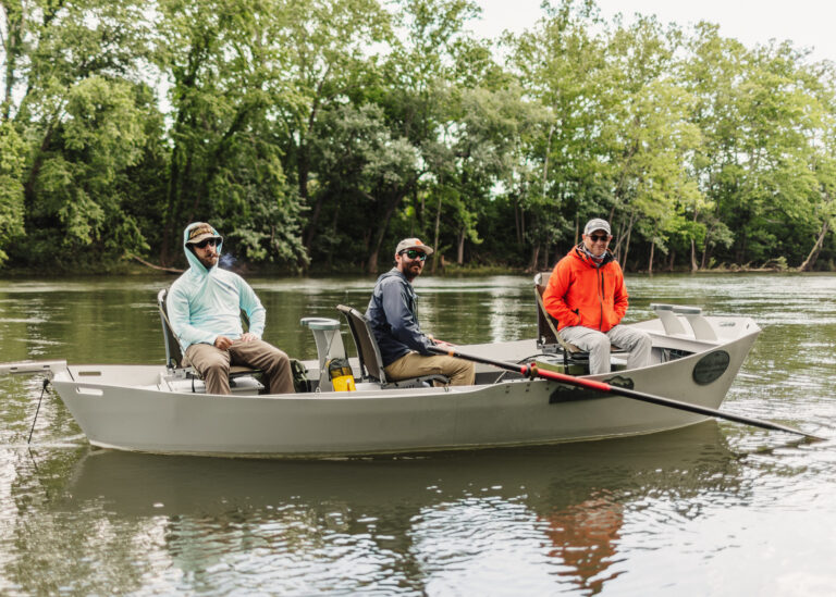 a group of men riding on the back of a boat