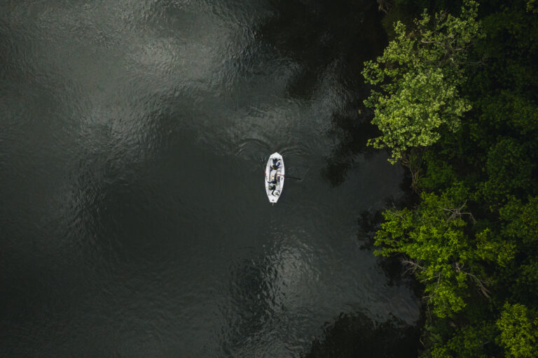 a white boat floating on top of a body of water