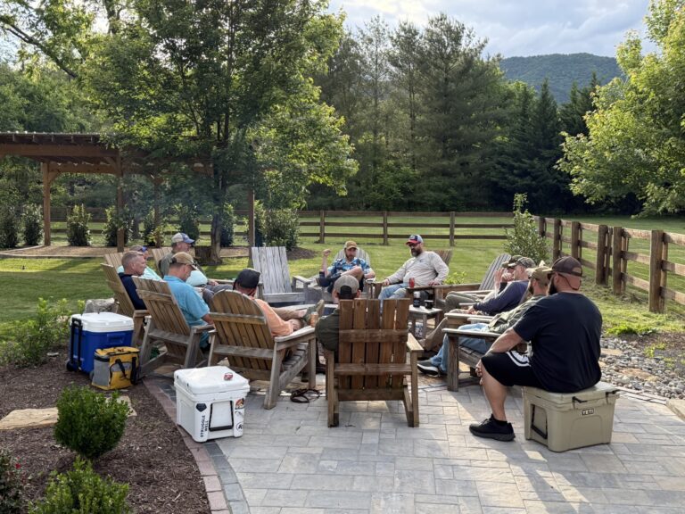 a group of people sitting around a wooden table