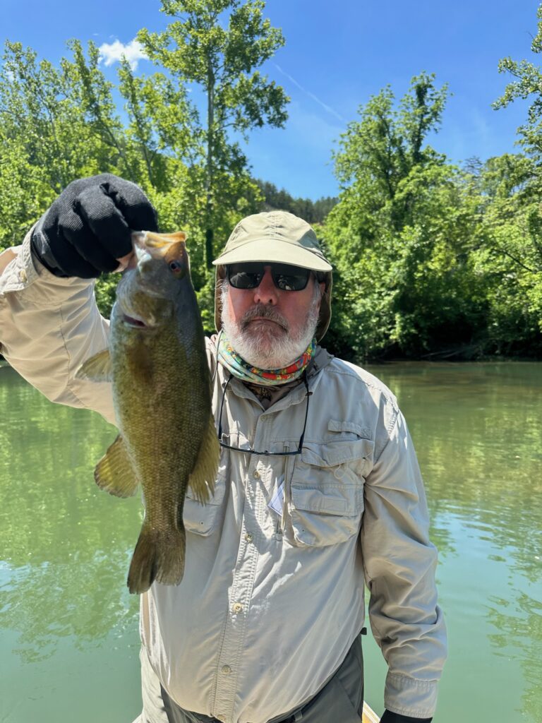 a man holding a fish on a boat