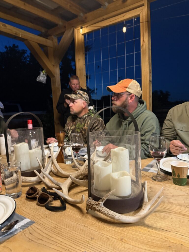 a group of people sitting around a table with food