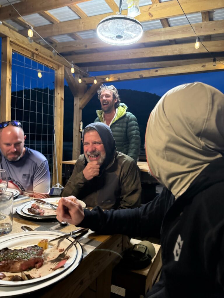 a group of people sitting around a table eating food