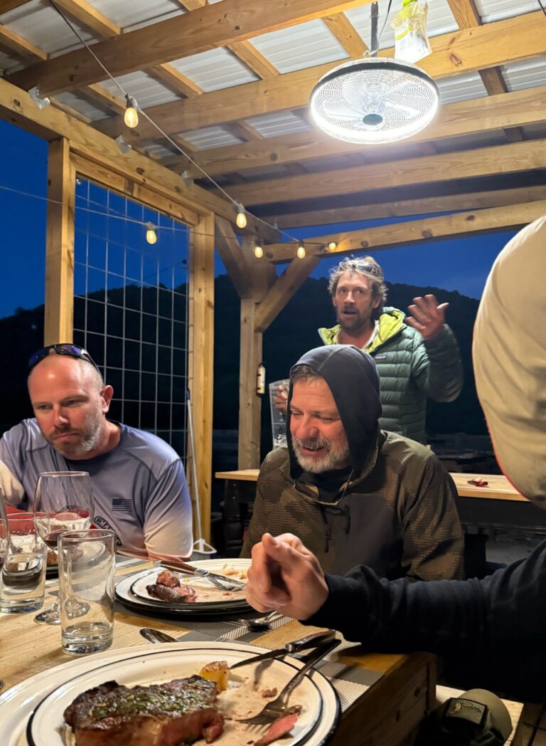 a group of people sitting around a table eating food
