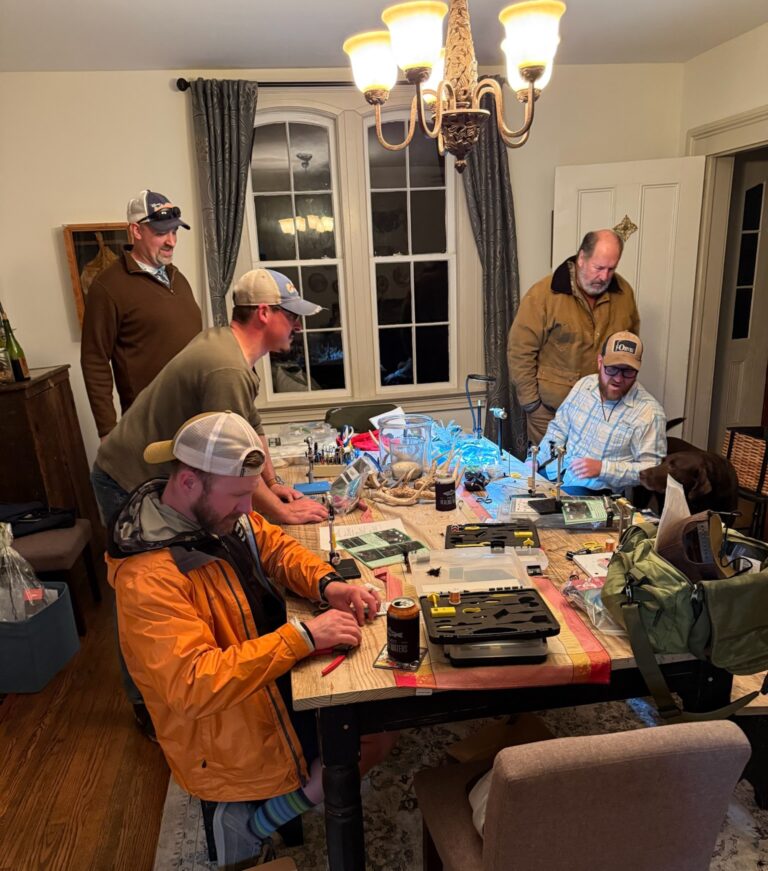 a group of men sitting around a table