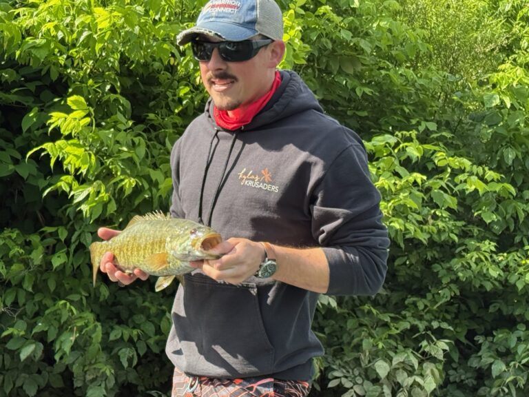 a man holding a fish in his hands