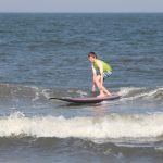 Boy learning surfing techniques and practicing