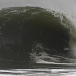 Overcast weather with guy surfing a huge wave