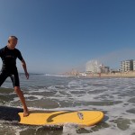 guy surfing on yellow surfboard in ocean city