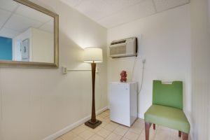 ac unit mini fridge lamp green chair