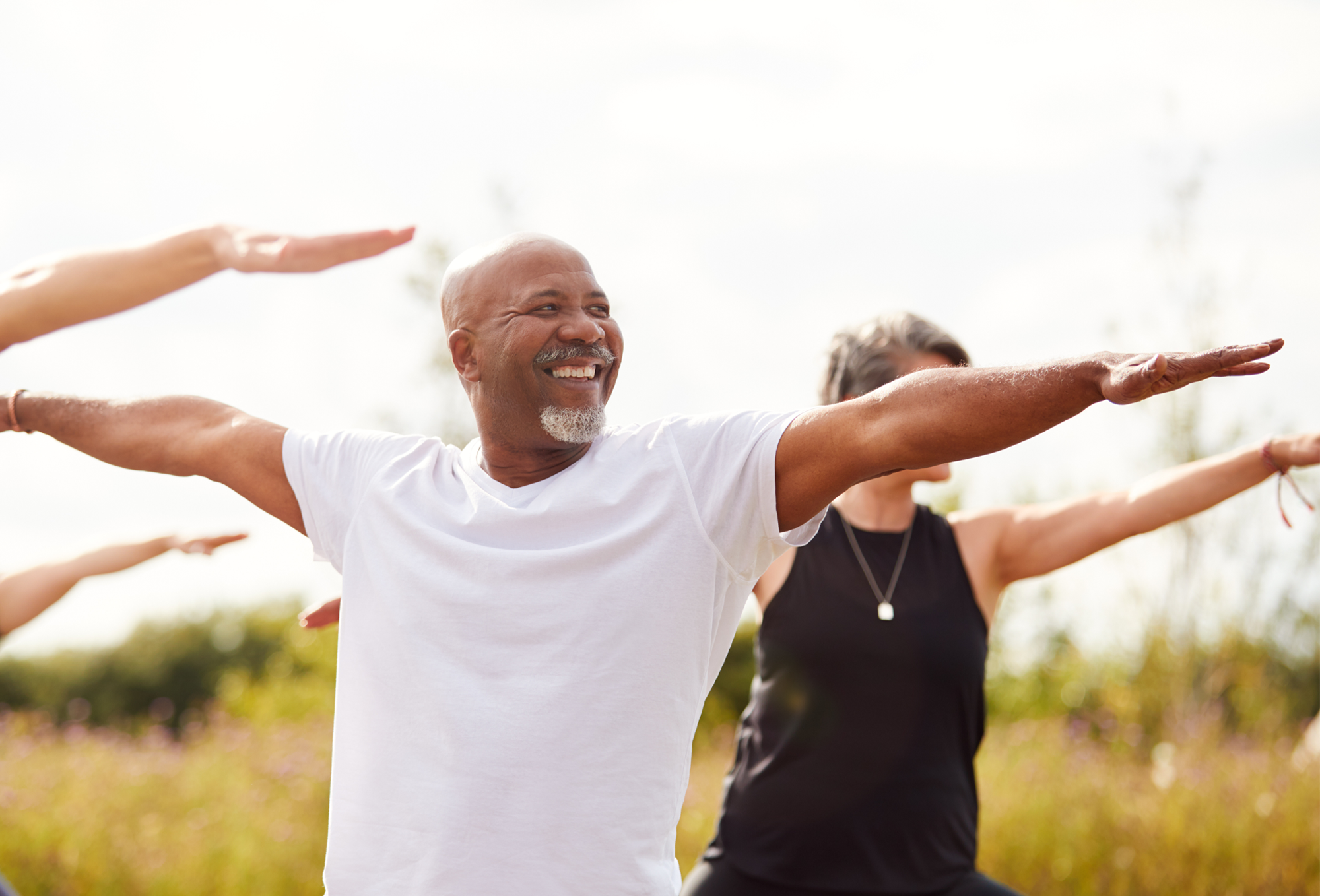 a group of people doing yoga in a field
