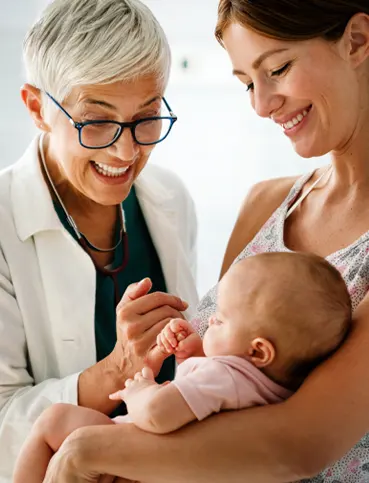 a woman holding a baby in her arms