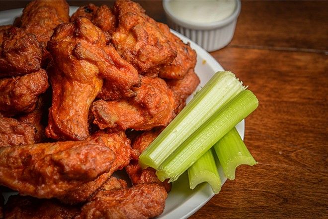 Buffalo wings on a plate with celery