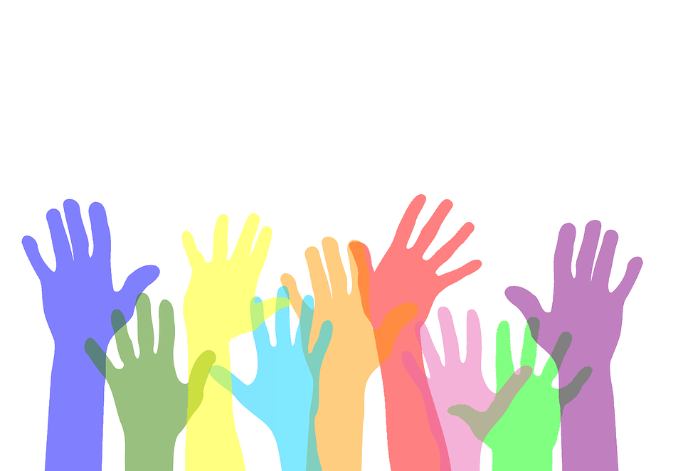 Colorful hands raised